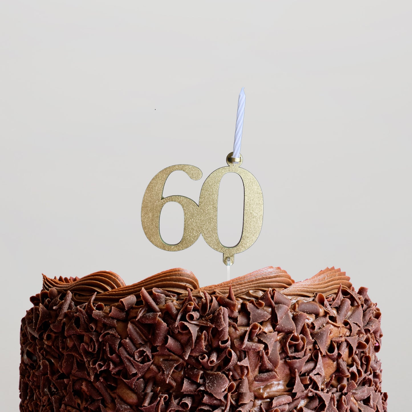 Cake topper 60 with candle.